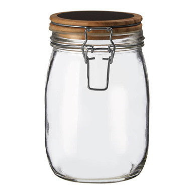 Clear glass jar with a wooden lid on a white background
