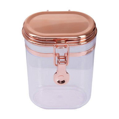 Clear container with rose gold lid and handle on a white background