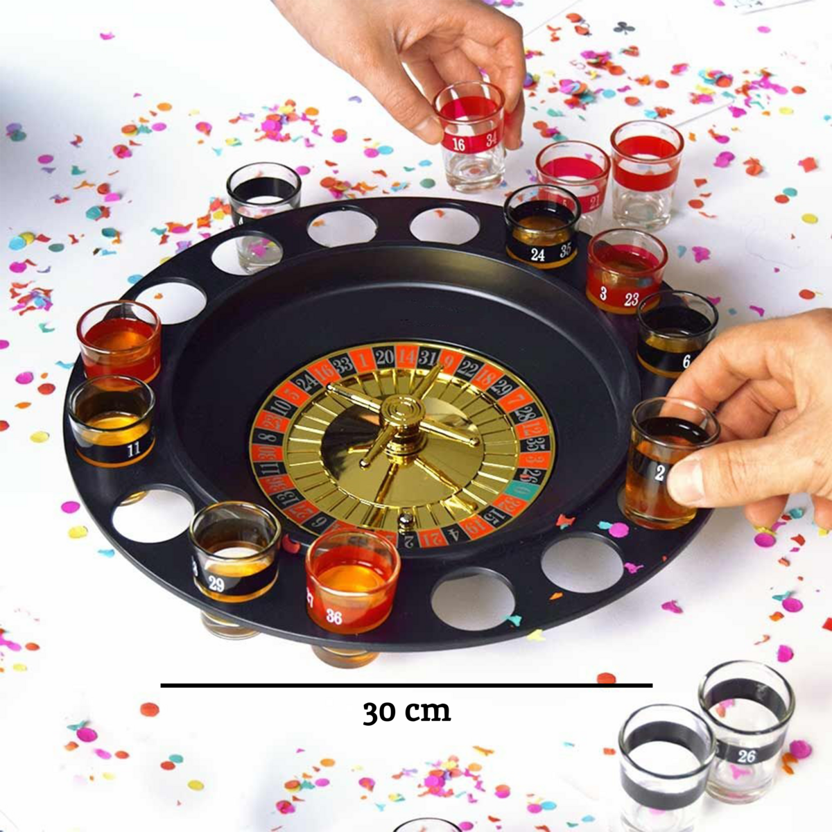 Alcohol roulette game with shot glasses on a table with confetti