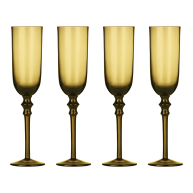 Four amber-colored champagne flutes with decorative stems on a white background