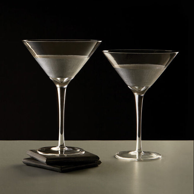 Two martini glasses on a dark background