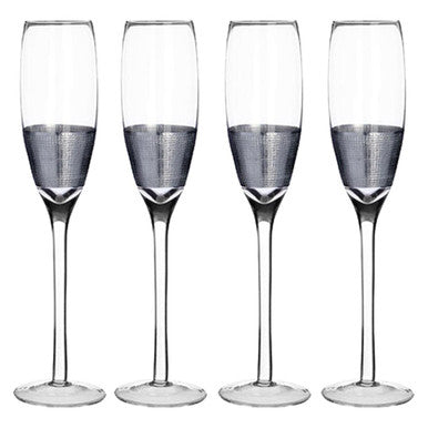 Four champagne flutes with textured glass on a white background