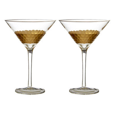 Two gold-rimmed martini glasses on a white background