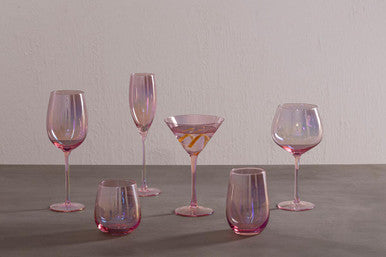 Set of colorful glassware on a gray surface with a neutral background