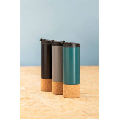 Three cylindrical containers with cork bases on a wooden surface against a light blue background