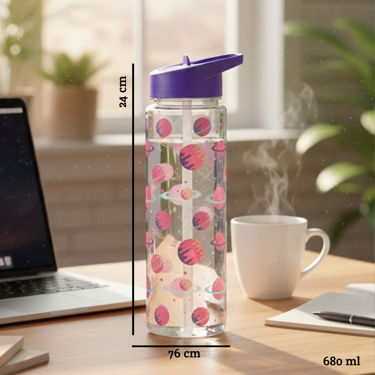 Clear water bottle with pink designs on a desk next to a laptop and mug