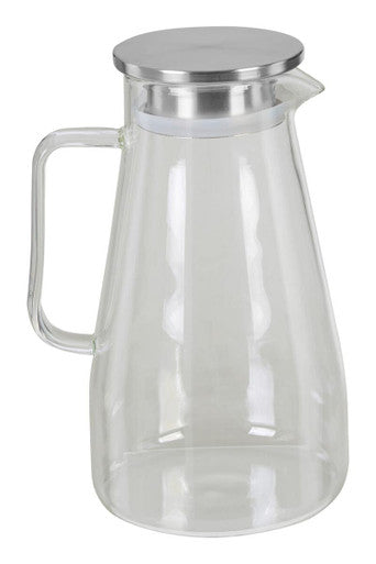 Clear glass pitcher with a silver lid on a white background
