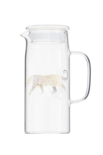 Clear glass pitcher with a leopard design on a white background