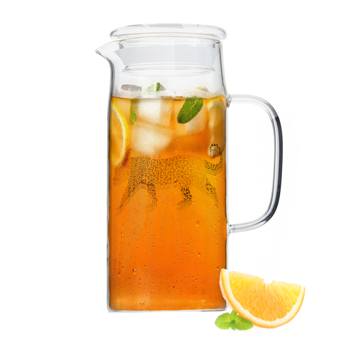 Clear glass pitcher filled with iced tea, lemon slices, and mint leaves on a white background