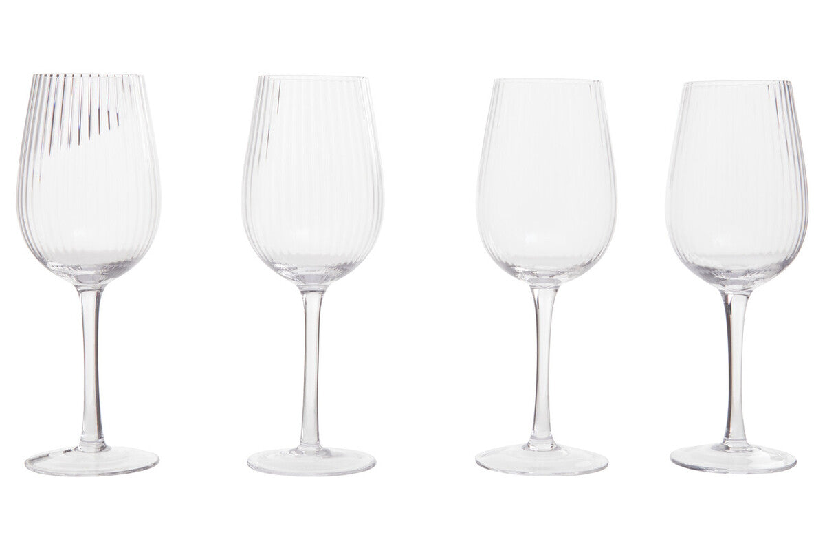 Four clear wine glasses with different designs on a white background