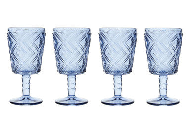 Four blue textured glass goblets on a white background