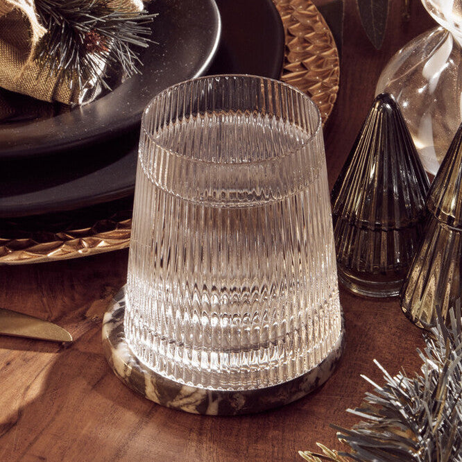 Decorative table setting with crystal candle holders and festive decorations on a wooden surface.