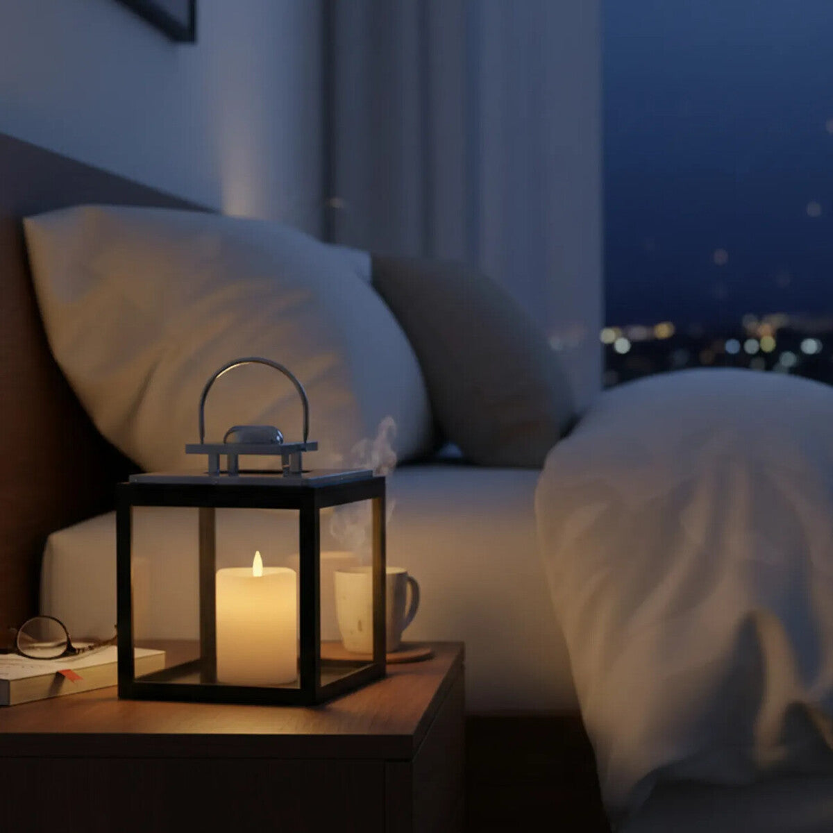 Candle in a lantern on a nightstand next to a bed with pillows, with a cityscape view outside.