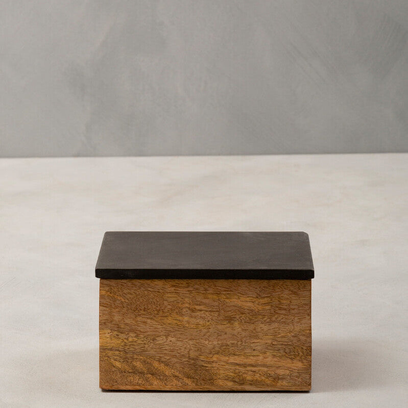 Wooden box with a black lid on a gray background
