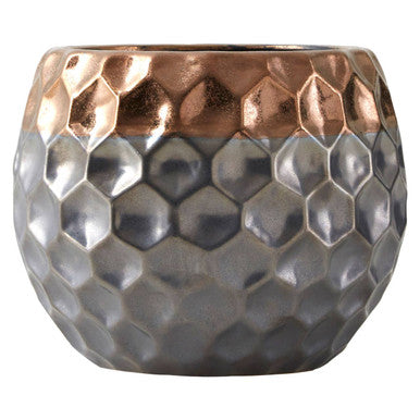 Decorative pot with honeycomb pattern and rose gold top on a white background