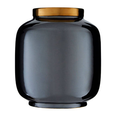 Dark glass jar with a gold lid on a white background