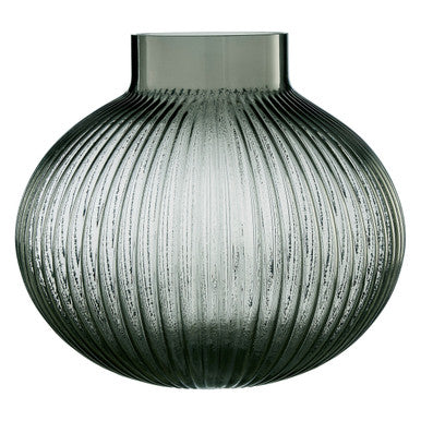 Decorative glass vase with ribbed texture on a white background