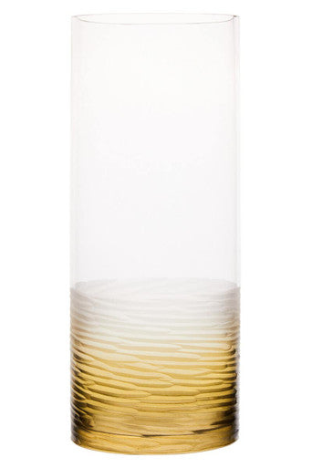 Tall cylindrical glass with gradient from white to gold on a white background