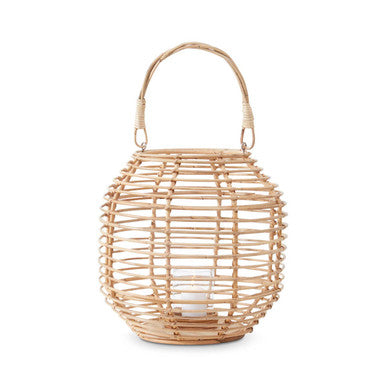 Woven rattan lantern with a handle on a white background