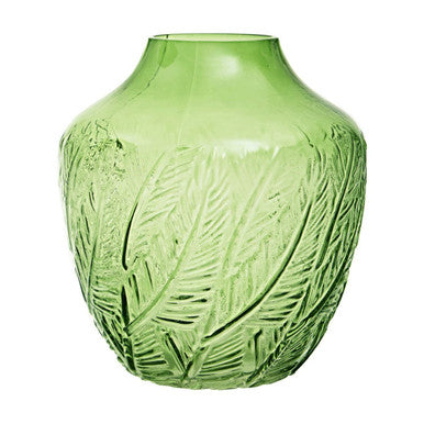 Green glass vase with leaf pattern on a white background
