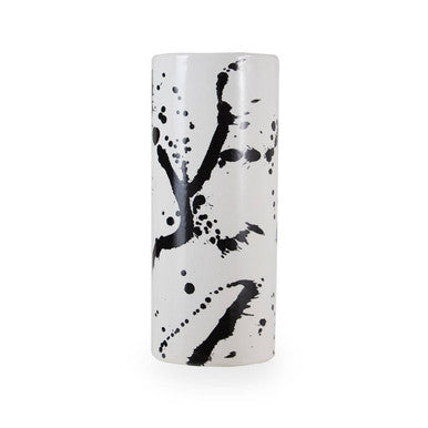Cylindrical white vase with black abstract patterns on a white background