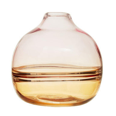 Glass vase with gradient color from pink to orange on a white background