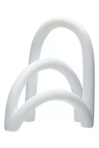 White plastic object with a curved design on a white background