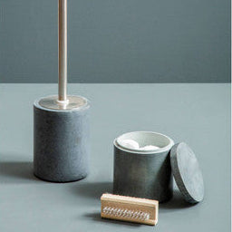 Set of bathroom cleaning tools including a brush, scrubber, and containers on a gray background