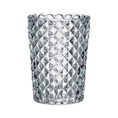 Clear glass candle holder with diamond pattern on a white background