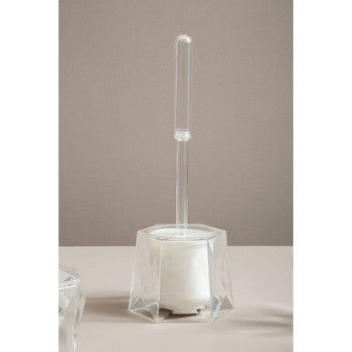 Clear glass holder with a white scrubber on a neutral background