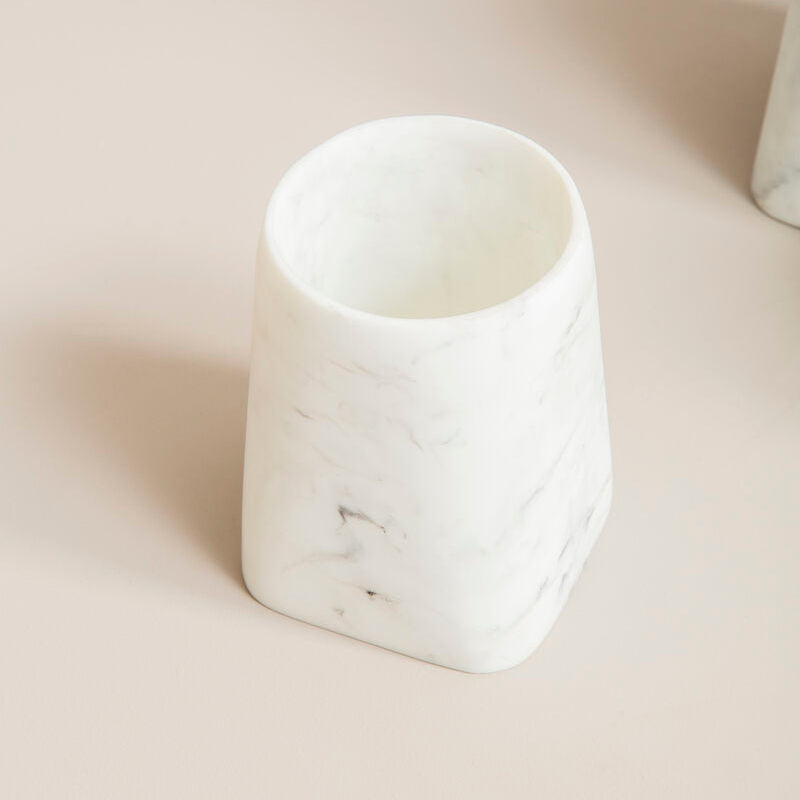 White marble-textured vase on a light beige surface