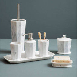 Marble bathroom accessory set on a tray with a dark gray background