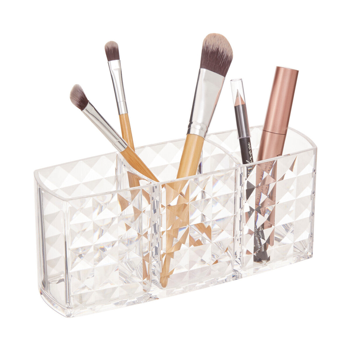 Clear acrylic makeup brush holder with various brushes on a white background