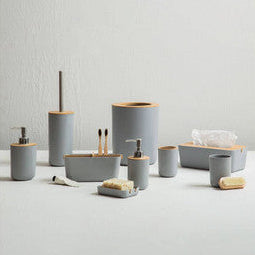 Bathroom accessories including cups, bowls, and a soap dish on a light gray background