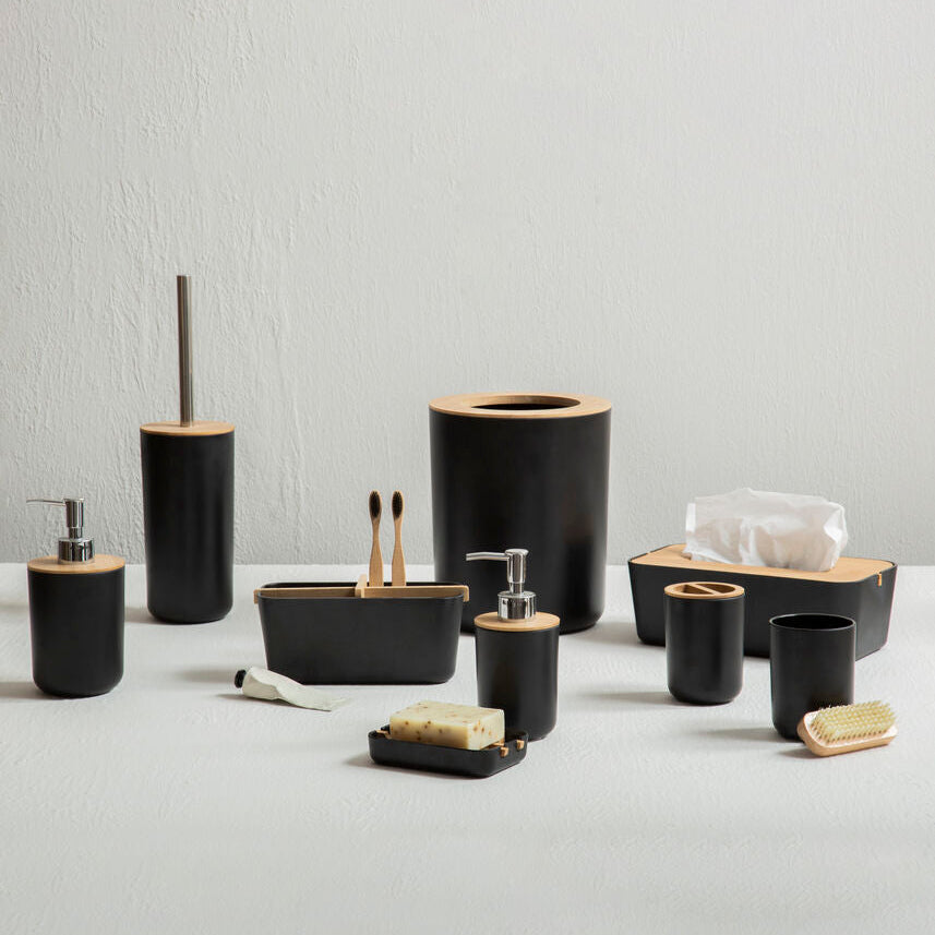 Black bathroom accessories set on a light gray background