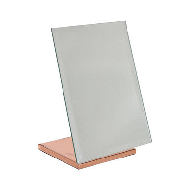 Rectangular mirror on a rose gold stand against a white background
