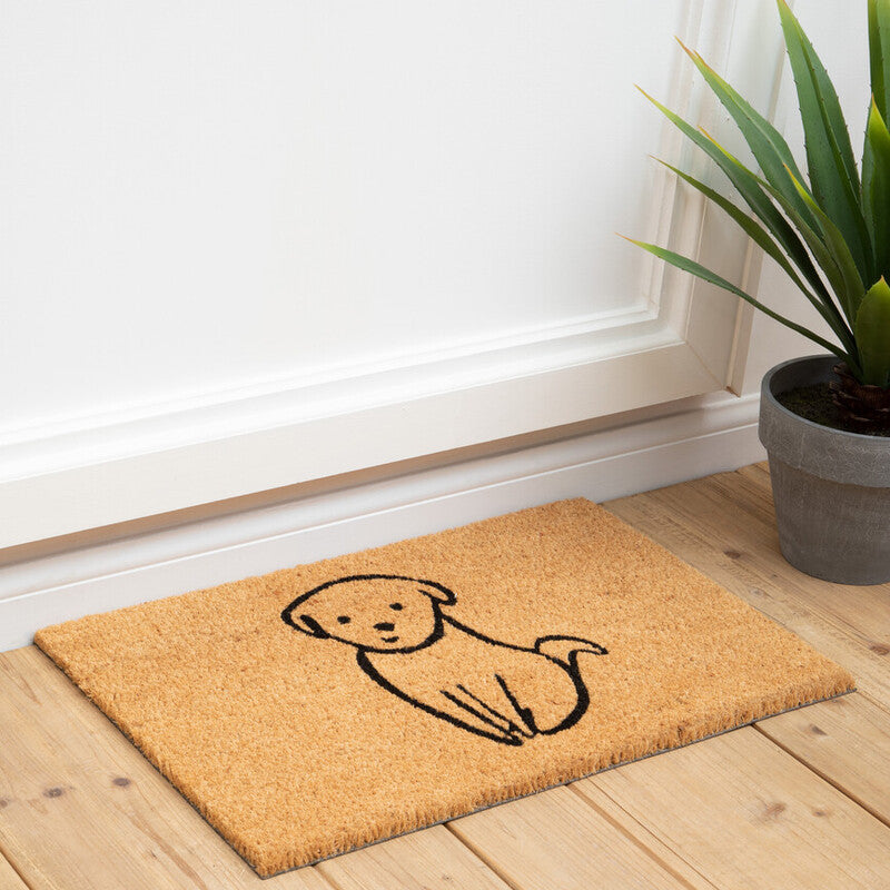 Doormat with a dog illustration on a wooden floor next to a plant