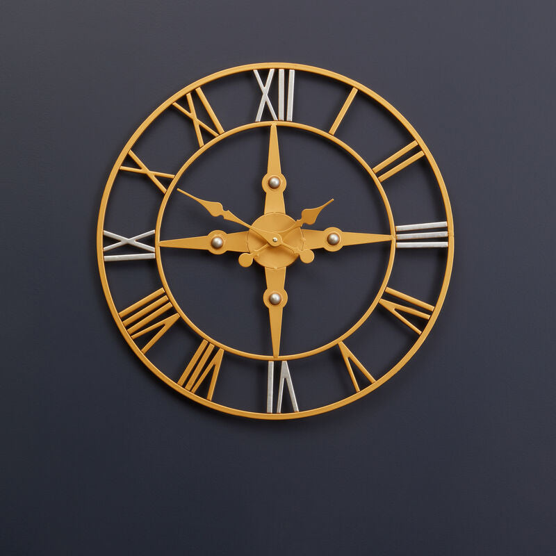 Gold wall clock with Roman numerals on a dark blue wall