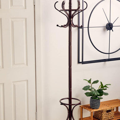 Coat rack with umbrella stand in a room with a plant and wooden bench.