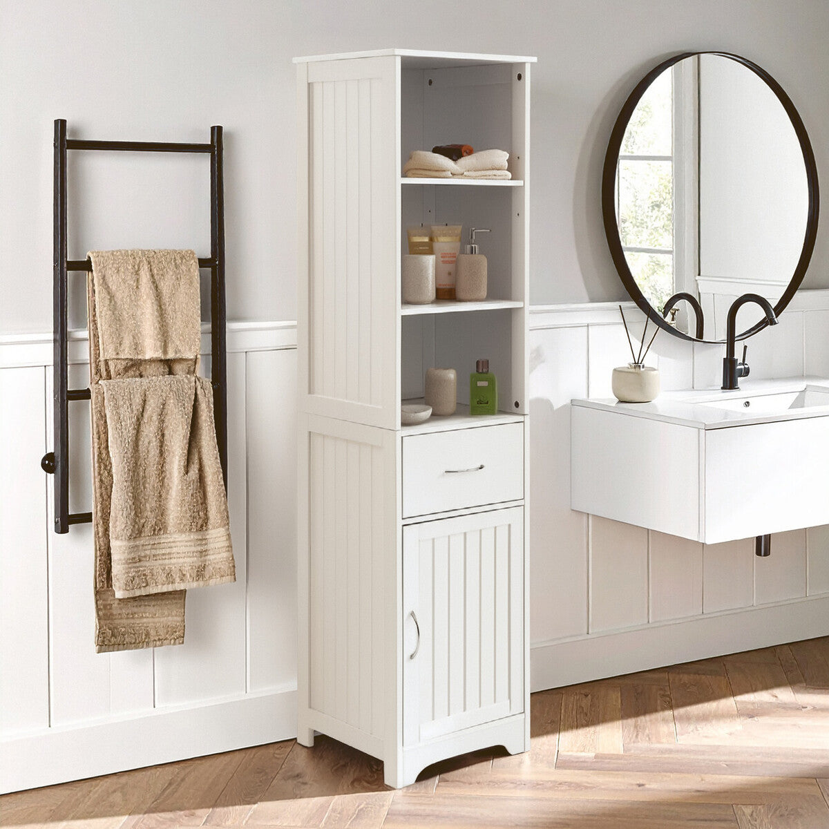 Bathroom with white tall cabinet, towel rack, and round mirror.