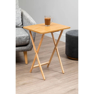 Wooden side table with a glass of coffee on a wooden floor.
