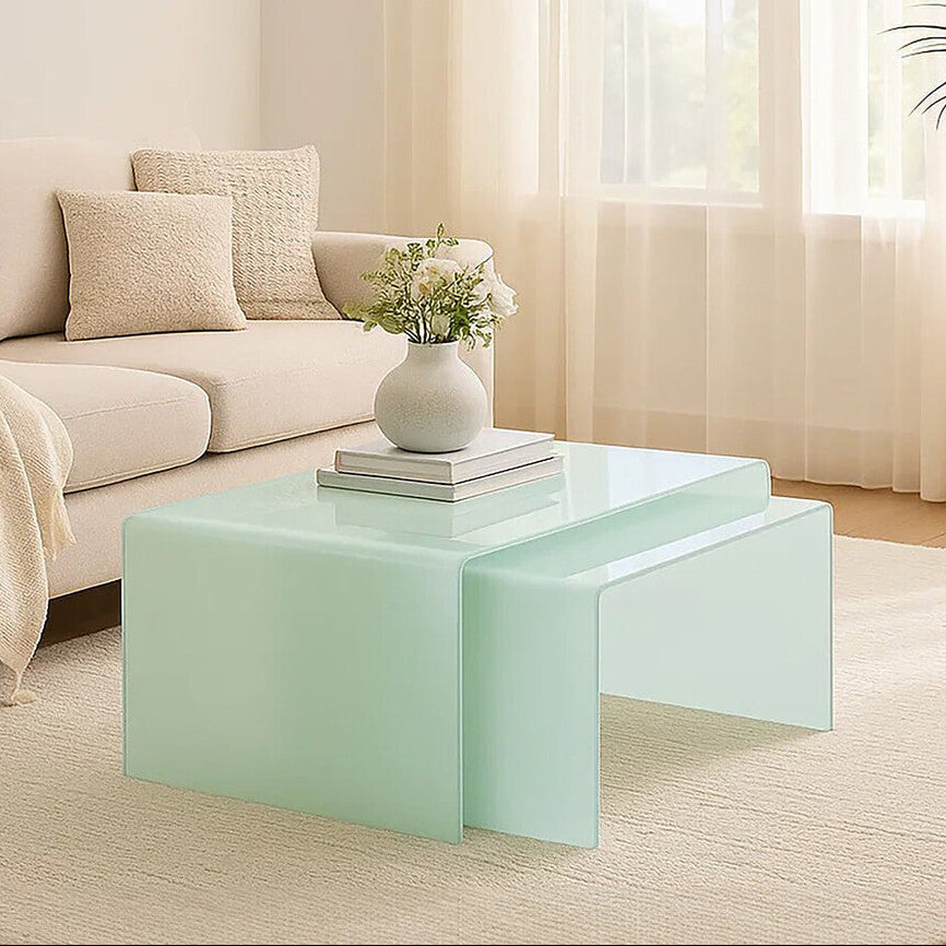 Light green coffee table in a living room with a beige sofa and decorative items.