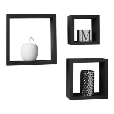 Set of three black square wall shelves with decorative items on a white background