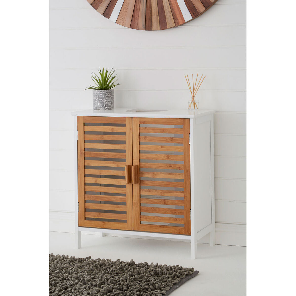 Wooden cabinet with slatted doors in a room with a white wall and wooden clock.