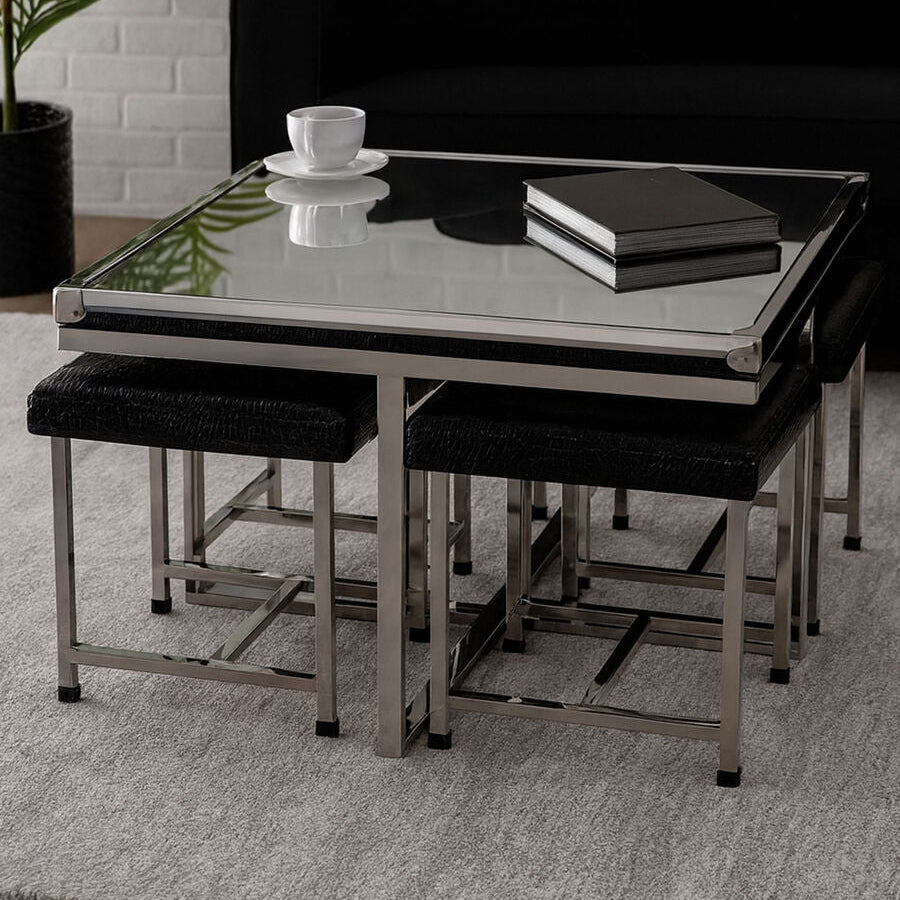 Glass dining table with black chairs in a modern living room setting