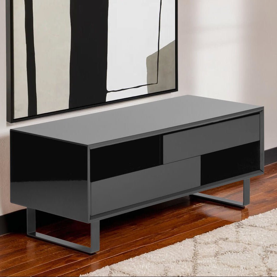 Modern black TV stand against a wall with abstract art