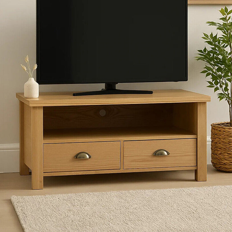 Wooden TV stand with a television, plant, and decorative items in a room.