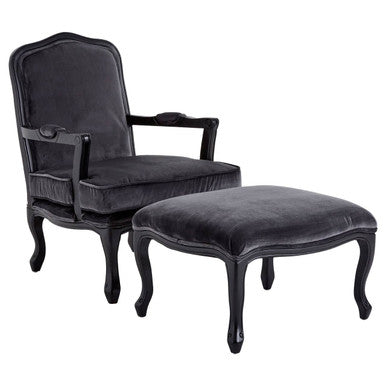 Black velvet armchair with matching ottoman on a white background