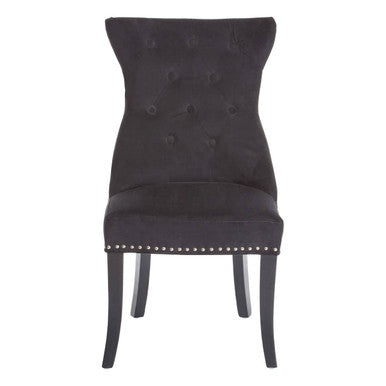 Black upholstered chair with button tufting and studded details on a white background