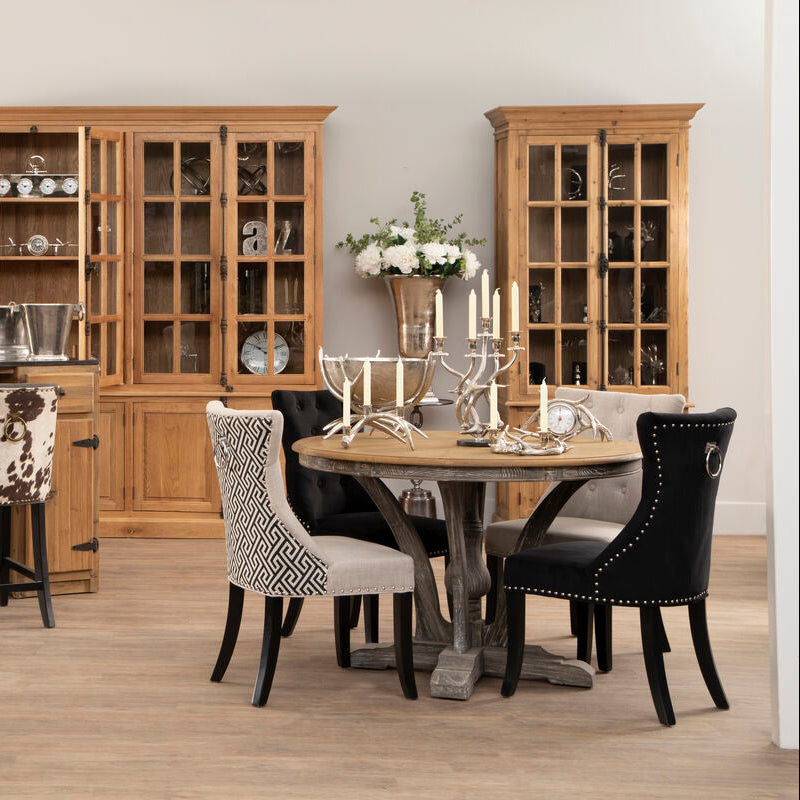 Dining room with wooden furniture, including a table and chairs, and decorative items.